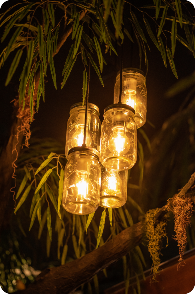 Lights inside mason jars hanging from the ceiling.