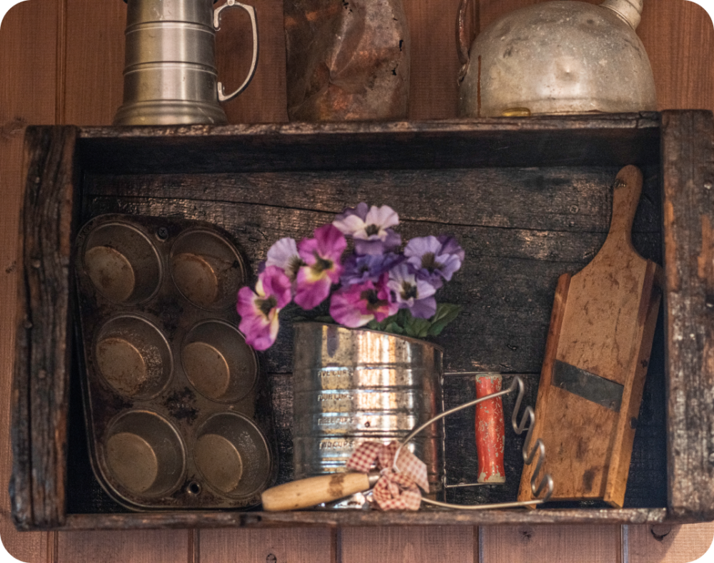 Rustic cookware hanging on a wall.